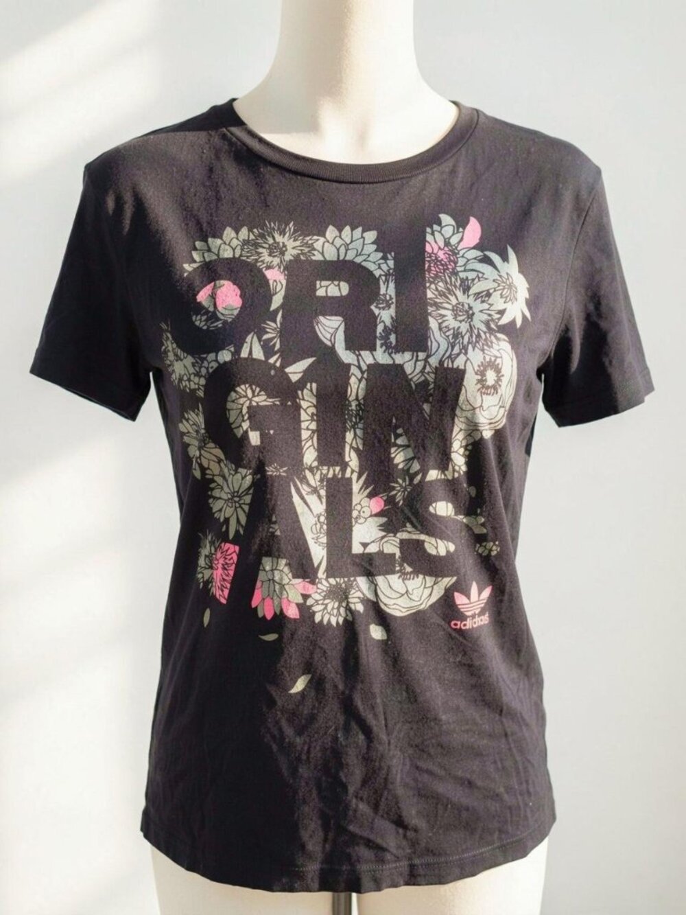 Adidas Originals black cotton tee with floral graphic and 'ORIGINALS' text